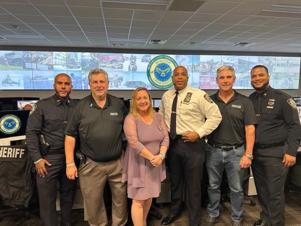 NYPD School Safety Division Inspector Kevin Taylor (center) poses with school safety officers and parents of Parkland victims during his visit to the massacre site. From left to right: Officer Capellan, Tony Montalto, Lori Alhadeff, Taylor, Tom Hoyer and Officer Peralta.