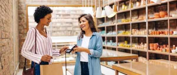 Ceramic store owner receives credit card.