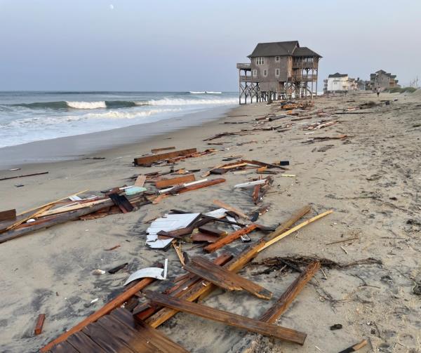 Wooden planks and other sections of the destroyed abode spanned hundreds of feet across the sand following the collapse.