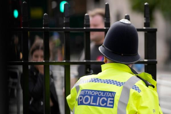 FILE - A view of a Metropolitan police officer on patrol, in London, on Oct. 1, 2021. London?s police force says that over 1,000 officers are currently suspended or on restricted duties as the department steps up efforts to root out bad cops following a scathing report that found it was institutio<em></em>nally racist, homophobic and misogynistic in a statement released on Tuesday Sept. 19, 2023. (AP Photo/Frank Augstein, File)