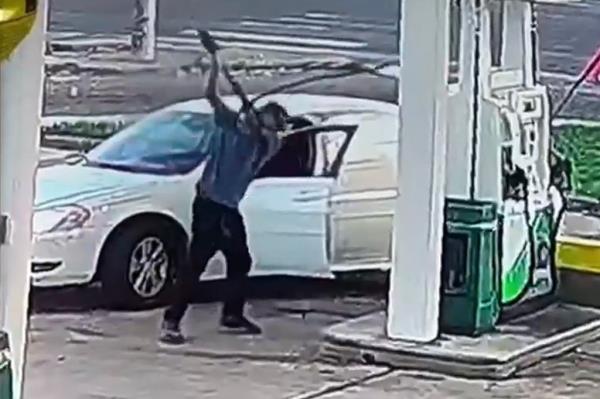 The enraged Impala driver gives the pump one final bash before it breaks off and gas begins to leak.