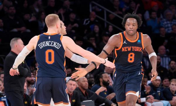 New York Knicks forward OG Anunoby #8 is greeted by New York Knicks guard Do<em></em>nte DiVincenzo #0 during a basketball game at Madison Square Garden.