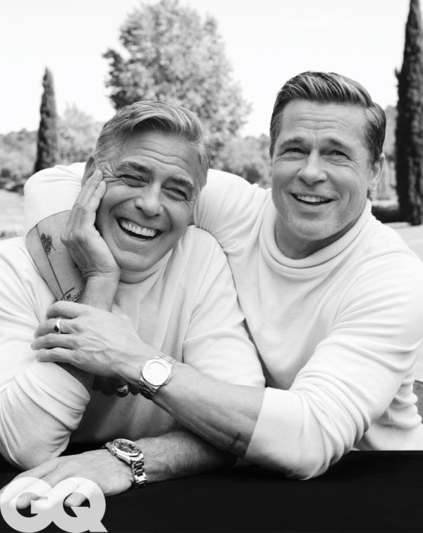 Brad Pitt and George Cloo<em></em>ney laugh in a photo for GQ's 2024 September Issue.