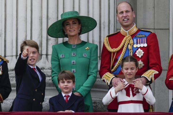 Prince William, right, Kate, Princess of Wales, centre, Princess Charlotte, bottom right, Prince George, left, and Prince Louis greet the crowd from the balcony of Buckingham Palace.