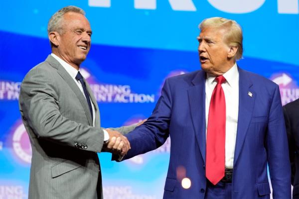 Republican presidential nominee former President Do<em></em>nald Trump shakes hands with Robert F. Kennedy Jr., at a Turning Point Action campaign rally, Wednesday, Oct. 23, 2024, in Duluth, Ga.