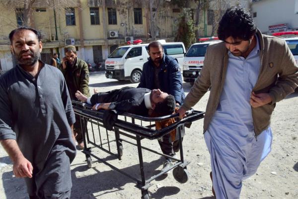 Workers and volunteers transport an injured victim from Pashin district's bomb blast upon arrival at a hospital in Quetta, Pakistan, on Feb. 7, 2024. 