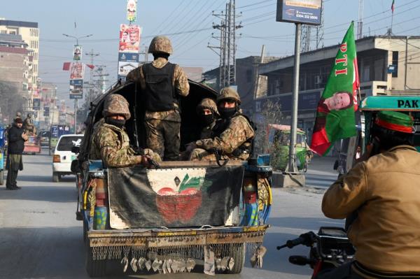 Pakistan Army perso<em></em>nnel patrol along a road in Peshawar on Feb. 7, 2024. 