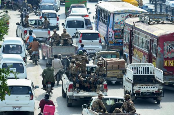 Army soldiers patrol on vehicles along a street in Karachi on Feb. 7, 2024, a day prior Pakistan's natio<em></em>nal elections.