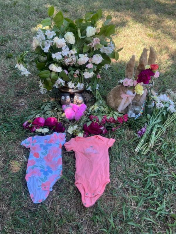 Image of memorial for twins with o<em></em>nesies and flowers