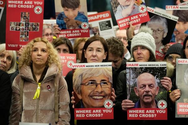 Protestors hold photos of those believed to be held hostage by Hamas.