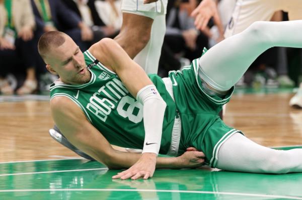 Kristaps Porzingis #8 of the Boston Celtics falls during a play against the Dallas Mavericks during the second quarter of Game Five of the 2024 NBA Finals at TD Garden on June 17, 2024 in Boston, Massachusetts.