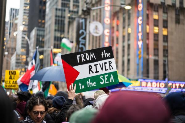 Protestor holding a sign reading 'From the river to the sea' during a Palestine demo<em></em>nstration outside Radio City Music Hall, March 28, 2024.