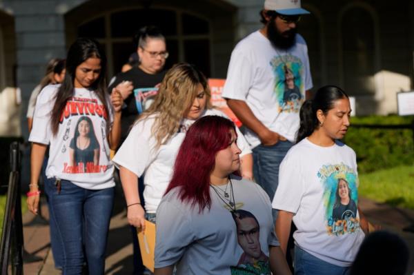 Families of the victims in the Uvalde elementary school shooting file out of the Uvalde County Courthouse 