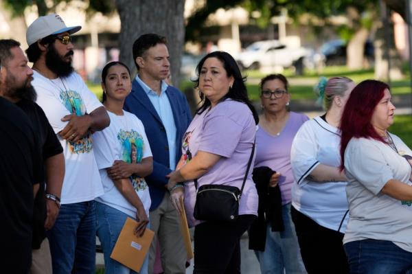 Families of the victims in the Uvalde elementary school shooting file out of the Uvalde County Courthouse