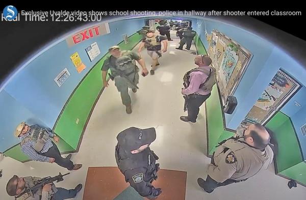 Uvalde surveillance footage showing the cops out in the hallway during the shooting