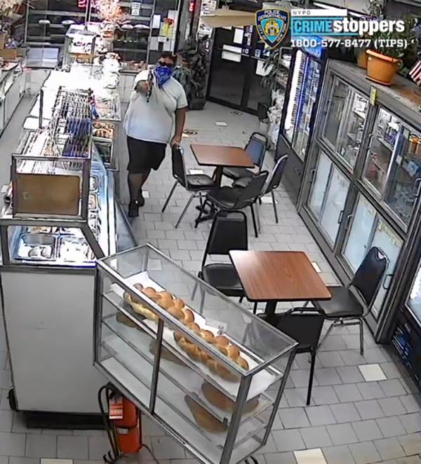 The bandanna- and sunglasses-wearing ruffian barged into the Paneoroma Italian Bakery on Jamaica Avenue near 96th Street in Woodhaven around 8 p.m. Sept. 23, flashed the large black weapon and demanded money, cops said.