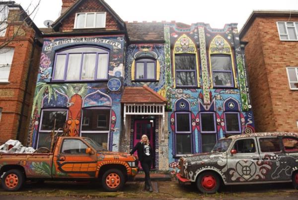 WILLIAM LAILEY / CATERS NEWS (PICTURED- Carrie Reichardt, 55, from Chiswick, London, first fell in love with mosaicking when she completed her garden in 1997.) - This mum has spent the last two decades covering the outside of her home in colourful mosaics. Carrie Reichardt, 55, from Chiswick, London, first fell in love with mosaicking when she completed her garden in 1997. Since then, she caught the bug for it and co<em></em>ntinued to cover her entire house in colourful mosaics which she says depicts the story of events that have happened throughout her life. She says that despite her house being - by far - the most colourful on her road that her neighbours love her designs. - SEE CATERS COPY