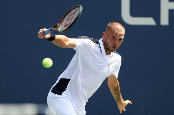 Daniel Evans of Great Britain returns against Karen Khachanov of Russia during their Men's Singles First Round match on Day Two of the 2024 US Open on Aug. 27, 2024.