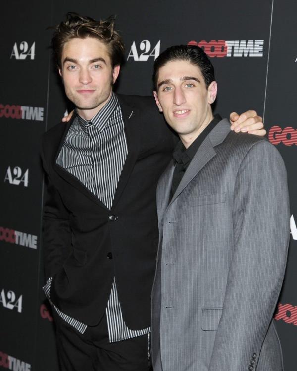 Robert Pattinson and Buddy Duress posing together on red carpet at 