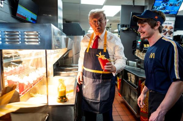 Former President Do<em></em>nald Trump (left) manned the french fry cooker at a McDonald's location in Pennsylvania on Sunday.