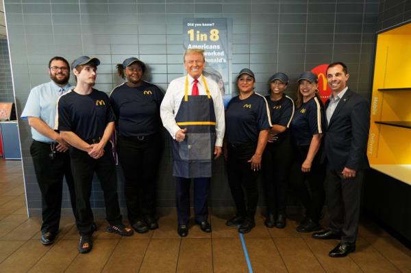 Trump is seen above posing with employees of the franchise in Feasterville, Pa. on Sunday.