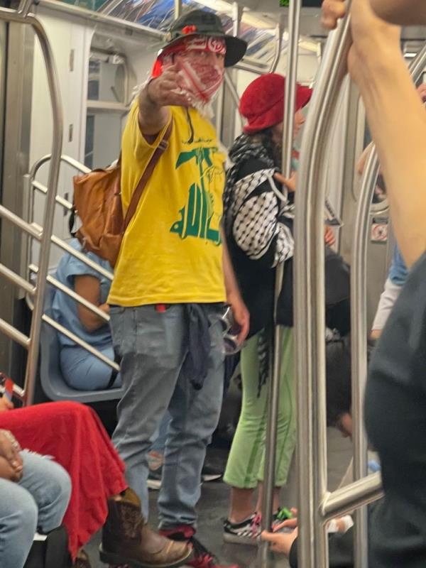 A photo taken of a protester in a Hezbollah t-shirt who harassed a Jewish man on a subway train.