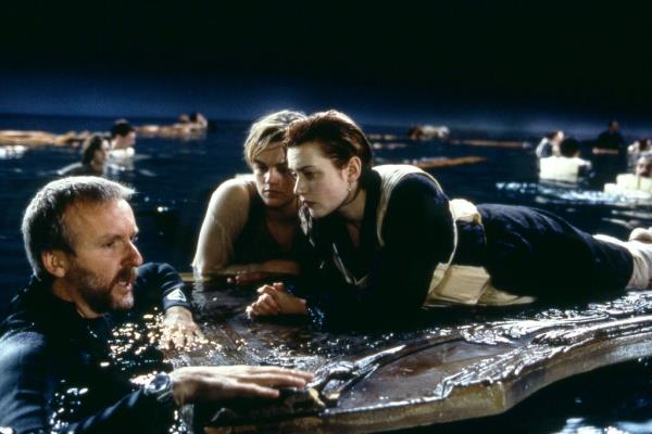 Director James Cameron works with Leo<em></em>nardo DiCaprio and Kate Winslet as they film the infamous 'door scene' in 