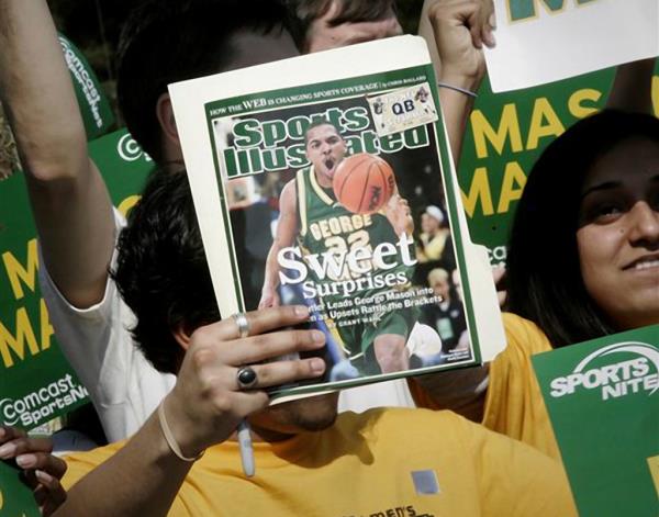 A George Mason University fan holds up a Sports Illustrated magazine at a send off for the team, March 29, 2006, in Fairfax, Va