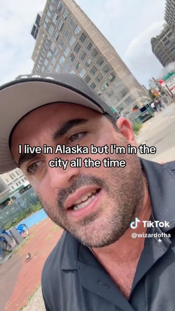 Jared Freid, wearing a hat walking down a city block, discussing out of town people saying they're in the city frequently on dating apps, in a viral TikTok video. Screenshot of TikTok video.