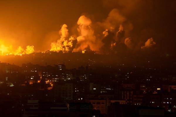 Fire and smoke rise after an Israeli airstrike in Gaza City on Sunday. 