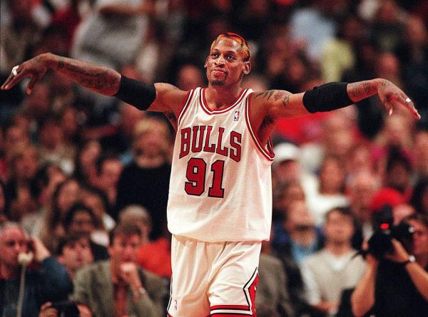 The Bulls' Dennis Rodman reacts after getting called for a technical foul for taunting the Hornets' Vlade Divac during a 1998 game at the United Center.