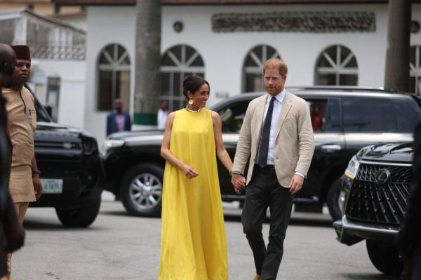 Prince Harry and Meghan, Duke and Duchess of Sussex, arriving at the State Governor House in Lagos, Nigeria for Invictus Games anniversary, holding hands.