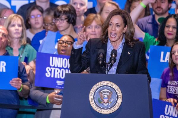 Vice President Kamala Harris speaking at a podium during a campaign event at IBEW Local Unio<em></em>n #5 in Pittsburgh, Pennsylvania.