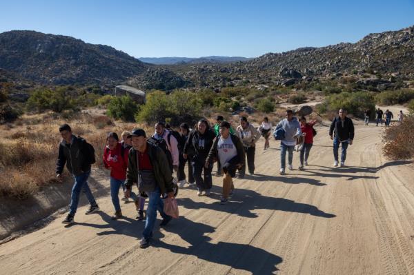 Colombian migrants walking along a desert road near Jacumba Hot Springs, California, post U.S-Mexico crossing on September 22, 2024