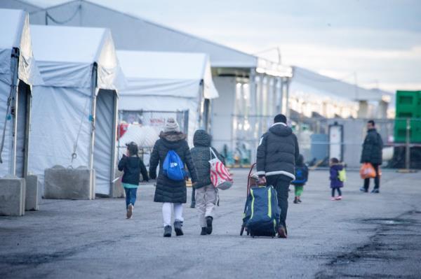 A group of migrants with luggage staying in tents at Floyd Bennett Field, Brooklyn, seen near Kings Plaza Shopping Center, January 10, 2024.