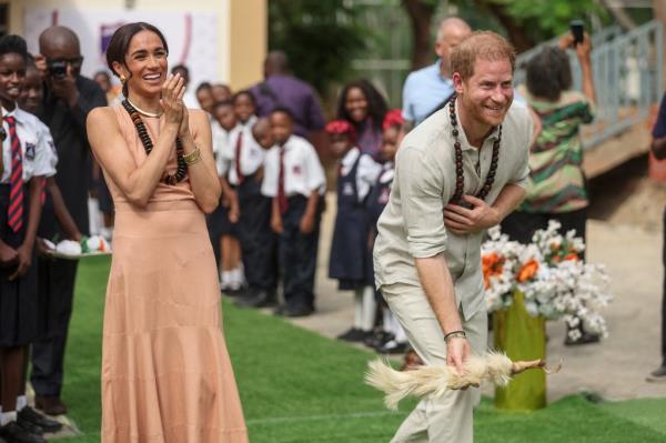 Harry and Meghan smiling. 