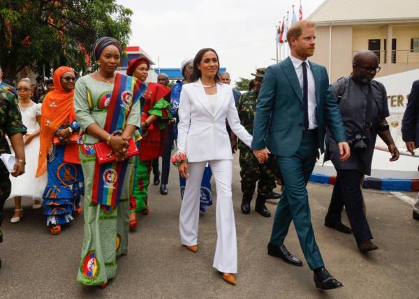 Harry and Meghan holding hands. 