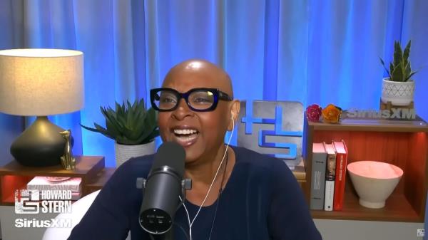 Robin Quivers bald, smiling. 