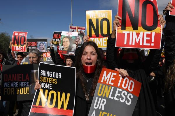 Relatives and friends of Israeli hostages held by the Palestinian Hamas movement since its October 7 attack in southern Israel, march near Kibbutz Orim.