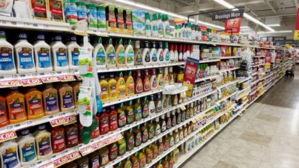 Grocery store shelf with cans of Great Value brand vegetables. Great Value is a Walmart brand product.