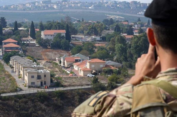 A Lebanese soldier mo<em></em>nitors the border area with the northern Israeli town of Metulla on October 8, 2023, after Lebanon's Hezbollah and Israel said they traded cross-border fire. Hezbollah said it carried out Sunday's assault 