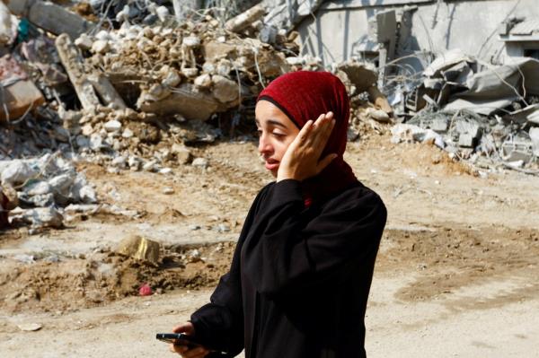 A woman gestures as people flee their homes amid Israeli strikes in the southern Gaza Strip, October 8, 2023.