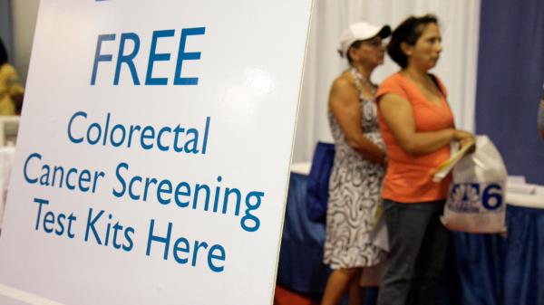 A free colorectal cancer screening test kit sign at the Health and Fitness Expo.