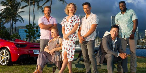 The cast of the Magnum PI reboot at a picnic table in front of the water for Magnum PI season 5