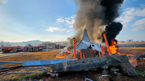 Reuters/Yo<em></em>nhap Part of a plane burns next to the runway 