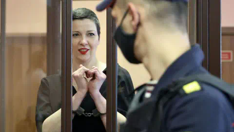 RAMIL NASIBULIN/BELTA/AFP Maria Kolesnikova, the last remaining protest leader still in Belarus, gestures making a heart shape inside the defendants' cage during her verdict hearing on charges of undermining natio<em></em>nal security, co<em></em>nspiring to seize power and creating an extremist group, on September 6, 2021 in Minsk.