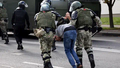 Getty Images Law enforcement officers detain a man during a rally to protest against the presidential election results in Minsk on September 13, 2020